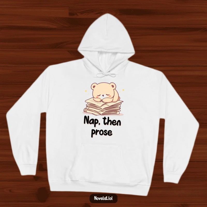 Funny hoodie with a docile bear character sleeping soundly atop a pile of manuscript papers. Warm and humorous apparel.